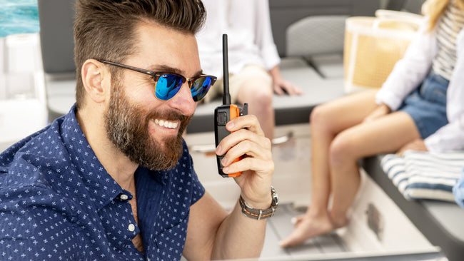Man on boat listens to marine radio