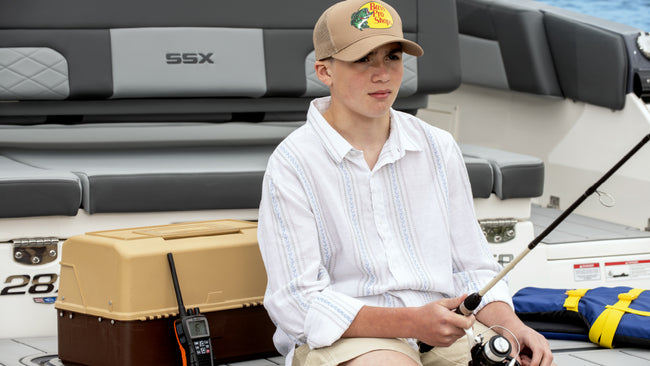 Young man fishing on a boat