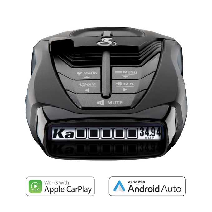 A black Cobra RAD 480i radar detector with a digital display showing radar band and frequency and compatibility with Apple CarPlay and Android Auto