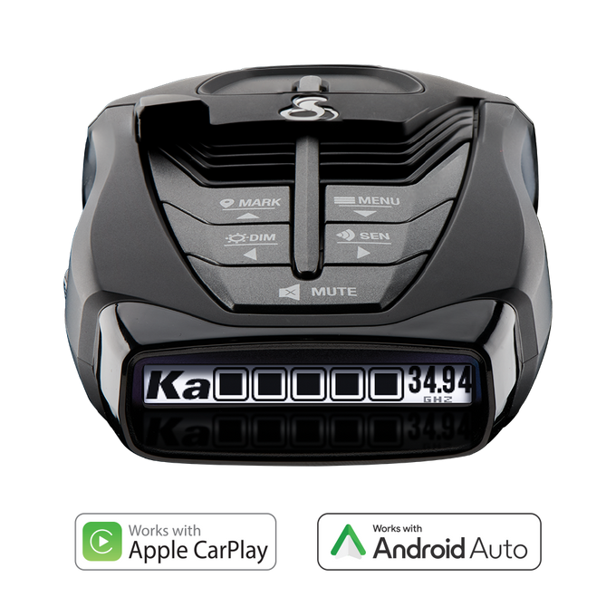 A black Cobra RAD 480i radar detector with a digital display showing radar band and frequency and compatibility with Apple CarPlay and Android Auto