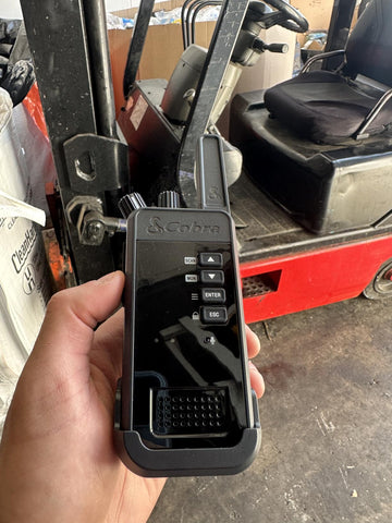 Hand holding a Cobra Performa 450 Two Way Radio.