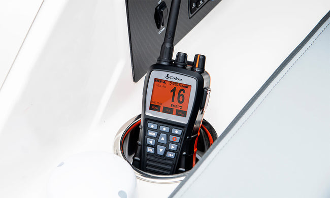 A black Cobra BlueBound 650 handheld marine radio inside of a white cupholder