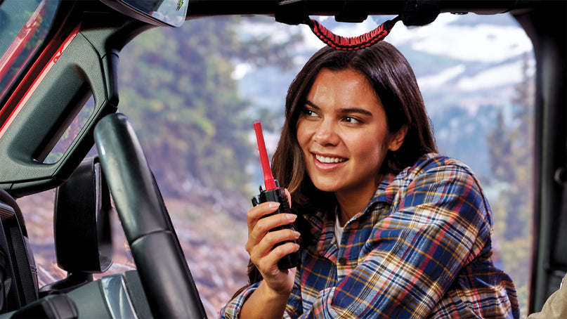 Woman speaks into Cobra Trailblazer 500 GMRS radio