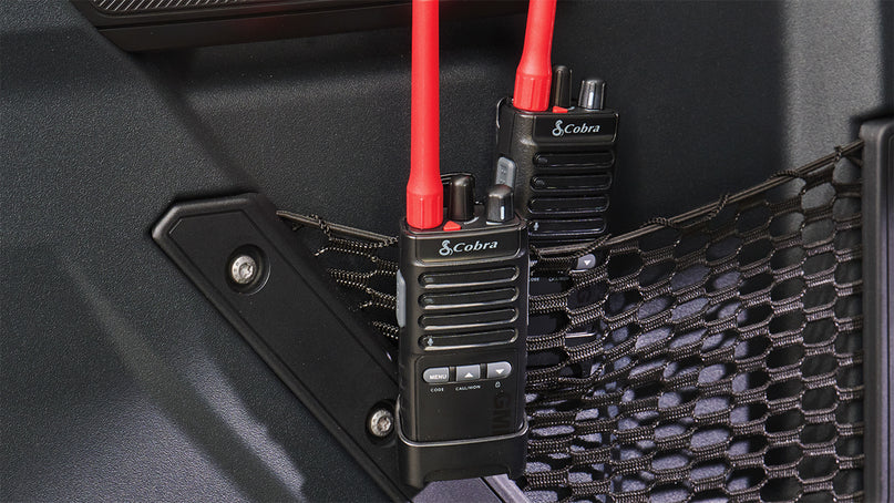 Cobra Trailblazer 500 GMRS radios clipped to mesh netting
