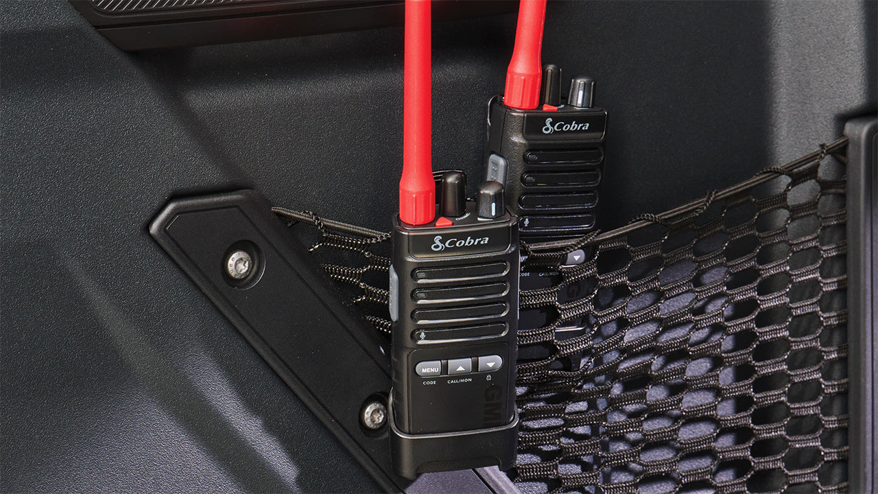 Cobra Trailblazer 500 GMRS radios clipped to mesh netting