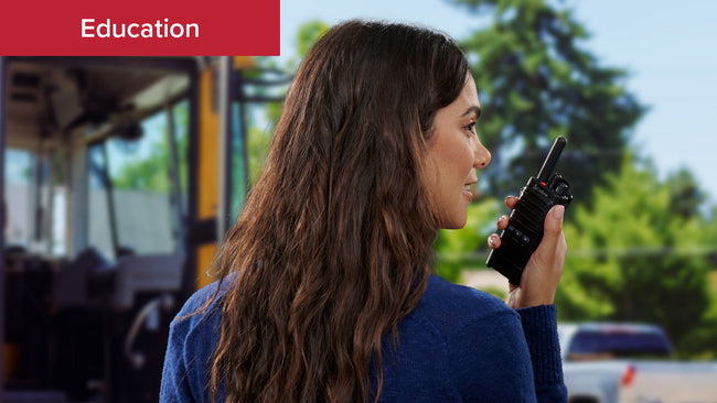 A teacher coordinates bus pickup using Cobra PX650 Business Walkie Talkie 