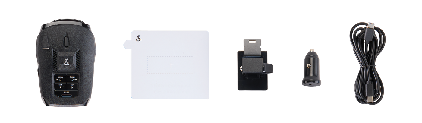 Items included in Cobra RAD 490i radar detector box from left to right: RAD 490i, mount adhesive, mounting bracket, USB-C power cable and 12v to USB-C power adapter